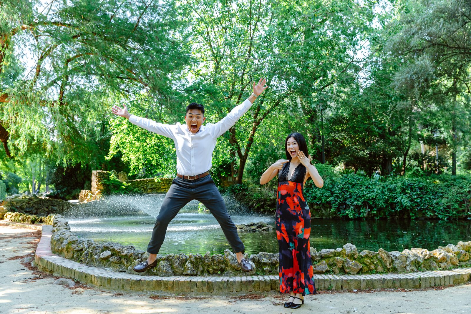 Rachel and Vinh jumping by a fountain in Seville